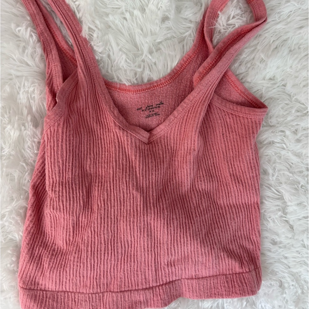 Out from under pink tank top